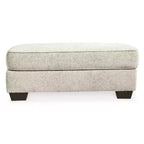 Pouf ottoman Monaghan Signature Design by Ashley, repose-pieds de salon rembourré en chenille couleur grès