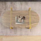 Table Basse Ovale en Verre MAYEERTY, Structure à 2 Niveaux Plateau en Verre Transparent et Étagère en Bois Noyer, Pieds Coniques avec Cadre Doré